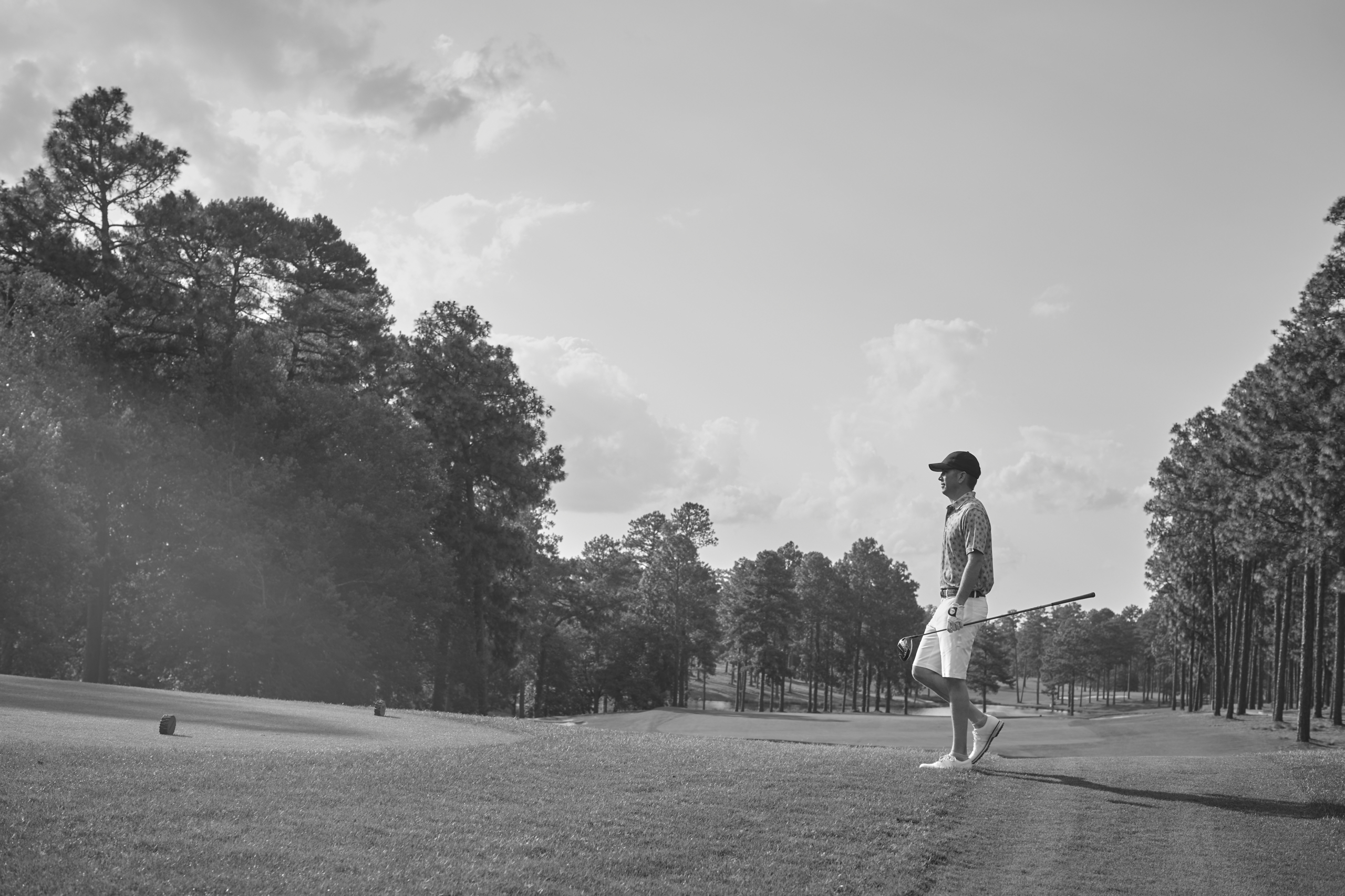 Grayscale image of man on golf course