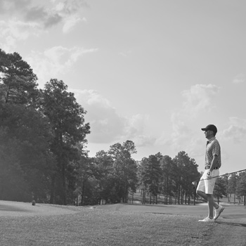 Grayscale image of man on golf course
