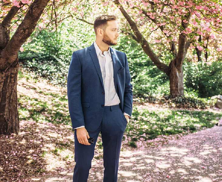 Man wearing suit standing in the forest