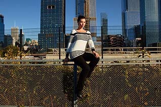 Woman sitting in front of train tracks